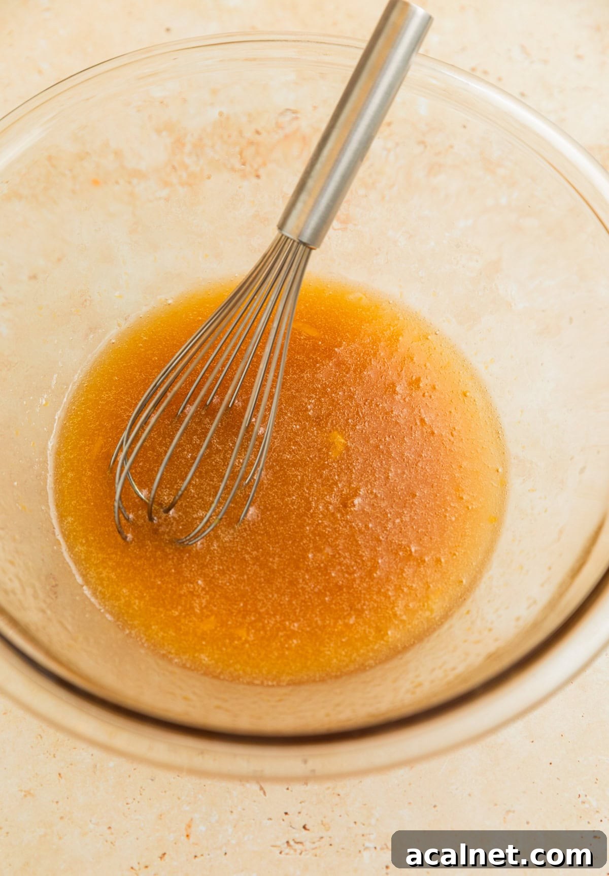 Butter, egg, oil and maple whisked together in glass bowl.