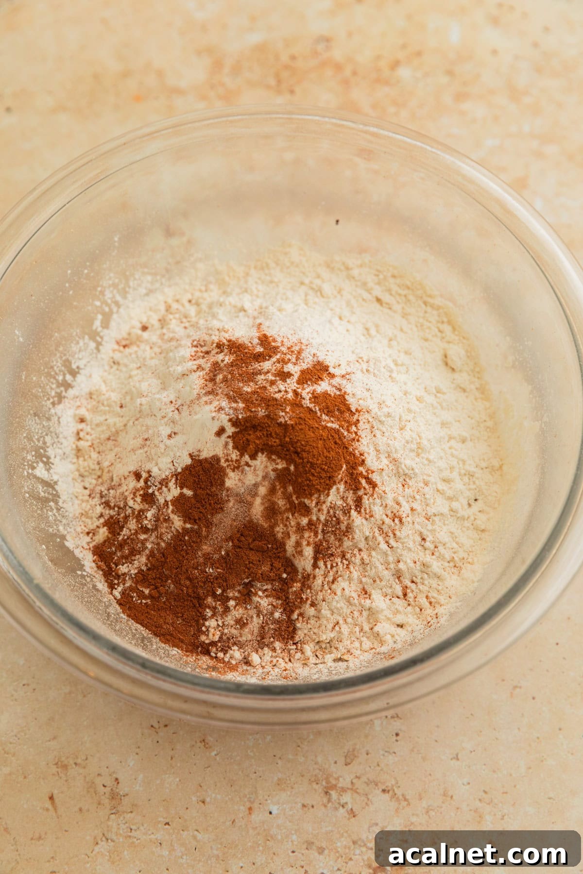 Cinnamon, flour and quick oats in bowl before stirring.