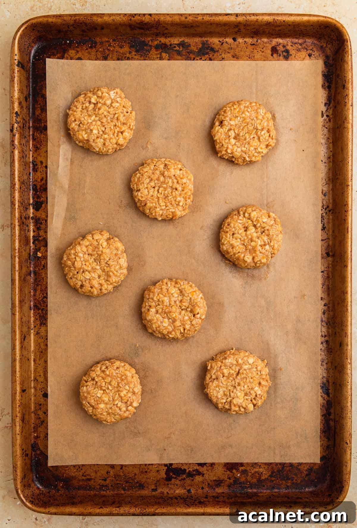 Cookie sheet with breakfast cookie dough arranged on parchment.