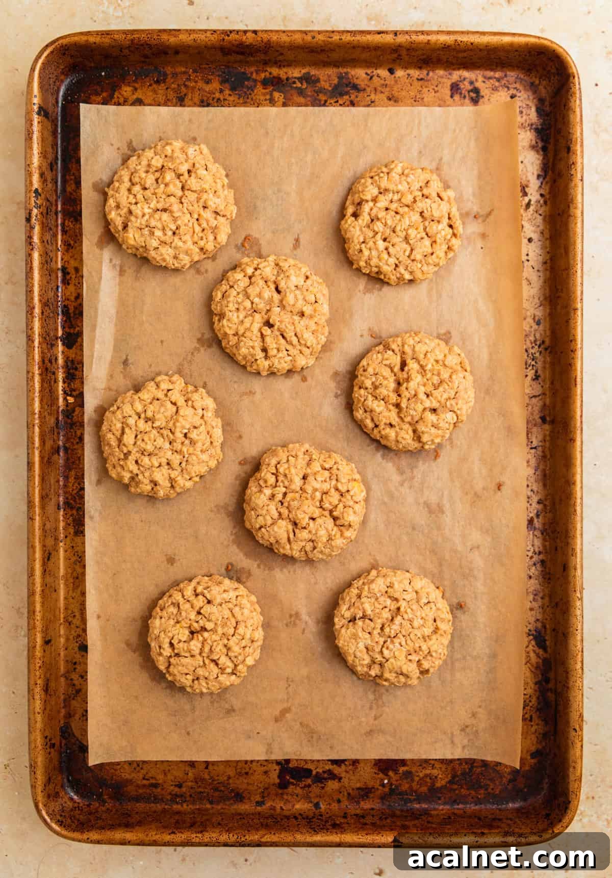 Baked cinnamon roll oatmeal cookies on cookie sheet.