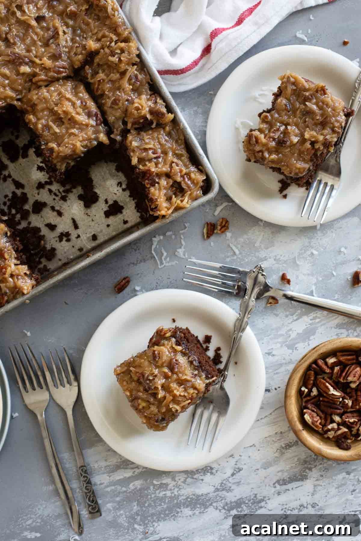 Slices of German Chocolate Cake on plates with the baking pan of cake nearby.