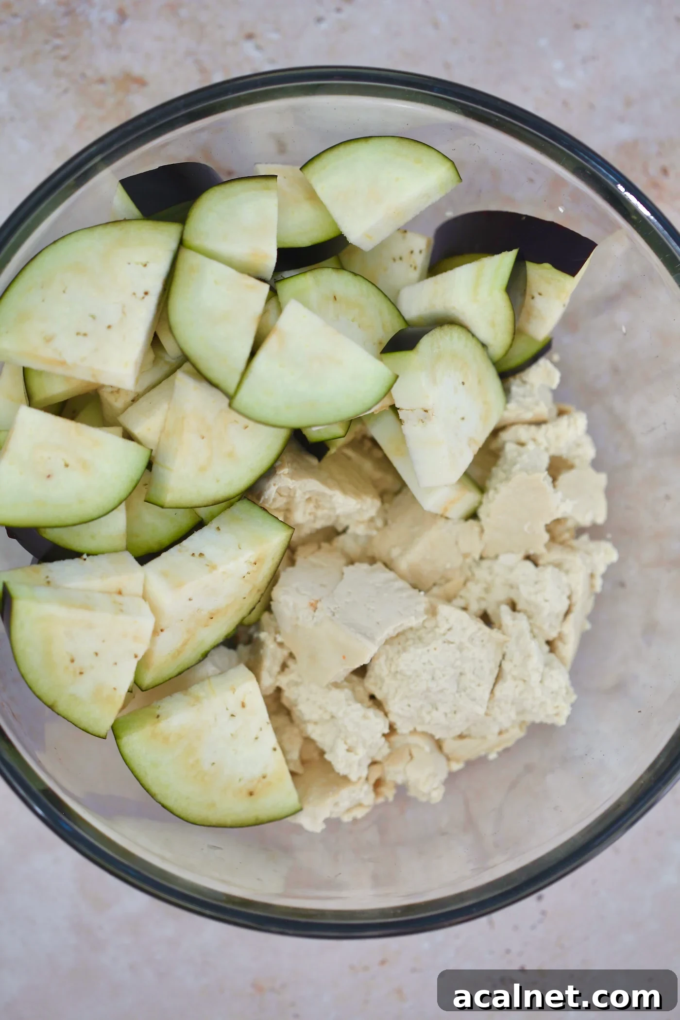 Mediterranean Tofu & Roasted Eggplant with Tahini Yogurt Sauce 3 torn tofu and chopped eggplant in bowl.