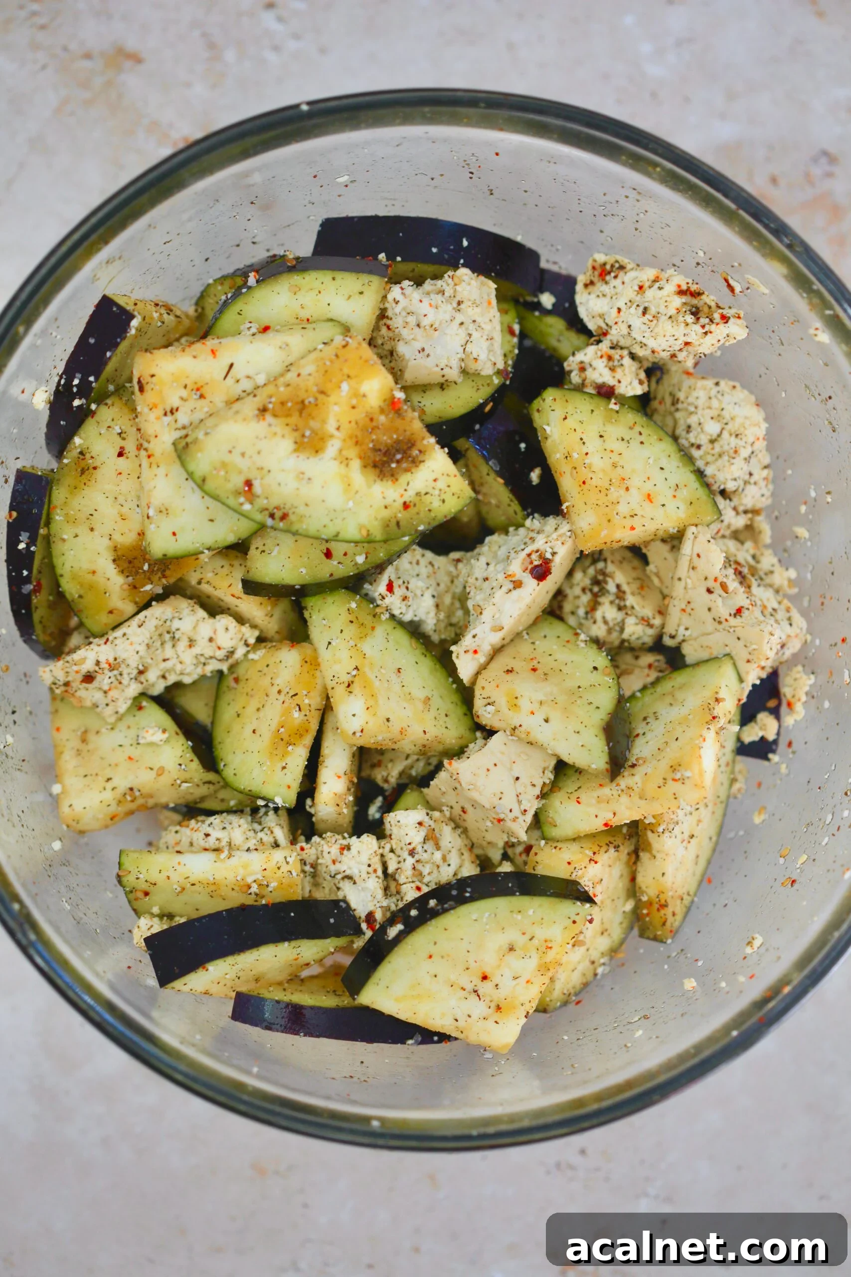 Mediterranean Tofu & Roasted Eggplant with Tahini Yogurt Sauce 5 seasoned eggplant and tofu in bowl.