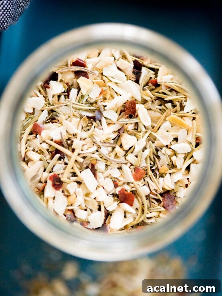 tuscan herb seasoning blend in a jar with a measuring spoon and plate