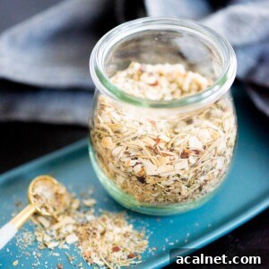tuscan herb seasoning blend in a jar with a measuring spoon and plate