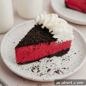 A slice of red velvet oreo cheesecake on a small white plate.