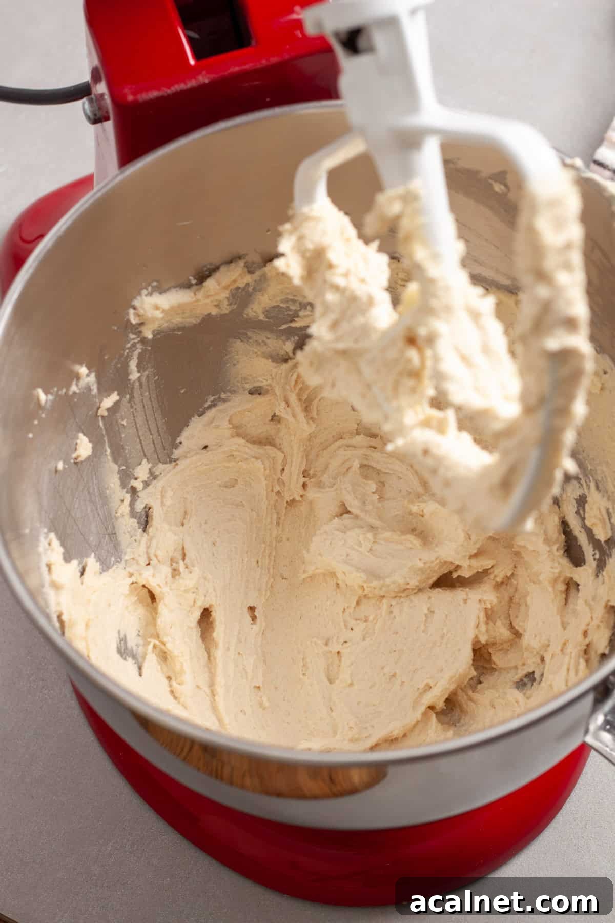 Butter and sugar whipped together in a  red stand mixer. 
