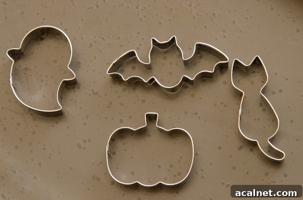 Halloween shape cookie cutters of a cat, ghost, bat and a pumpkin