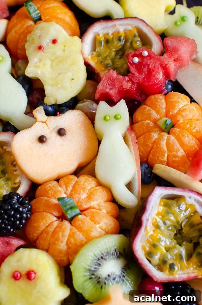 Halloween Fruit Salad with shapes of cats, pumpkin,ghost and bats with edible eyes