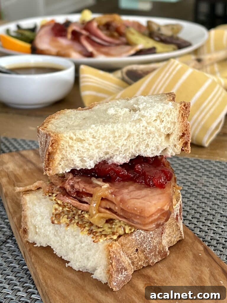 Ham sandwich using leftover ham on cutting board.