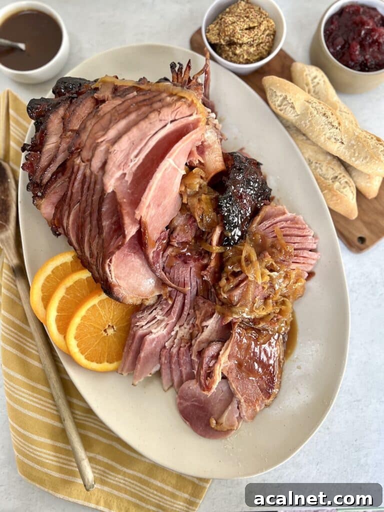 Baked ham on platter with accoutrements.