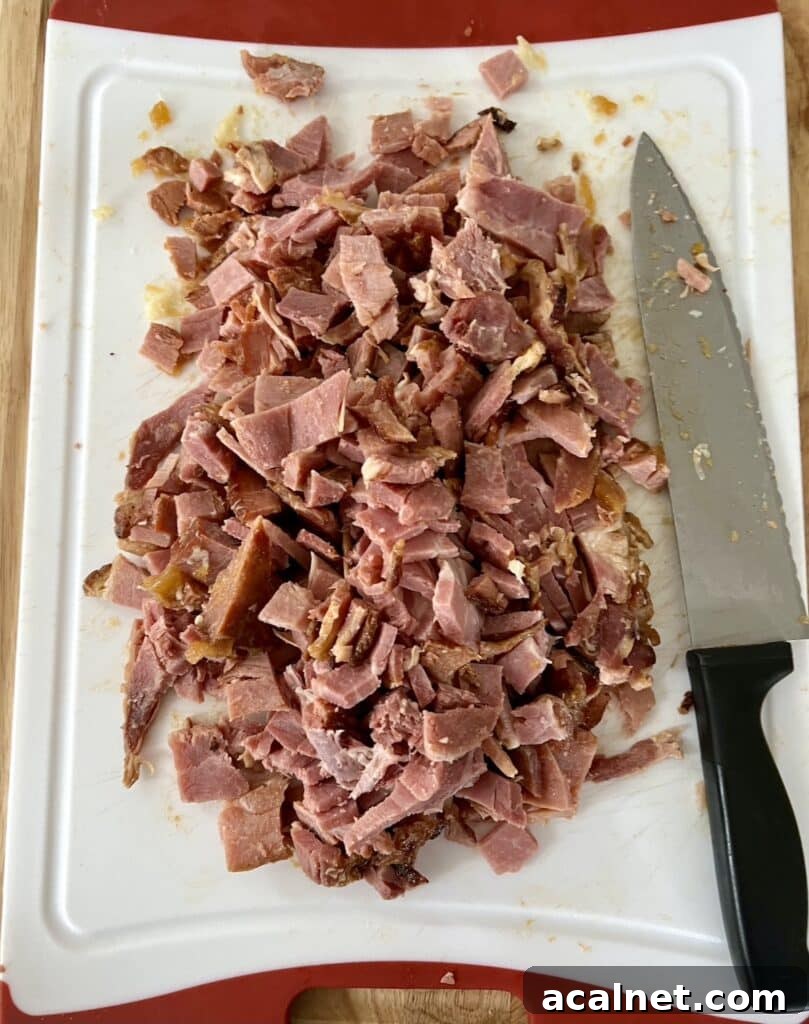 Can you refreeze ham that has been already baked? Photo of leftover ham being diced for packaging in freezer.