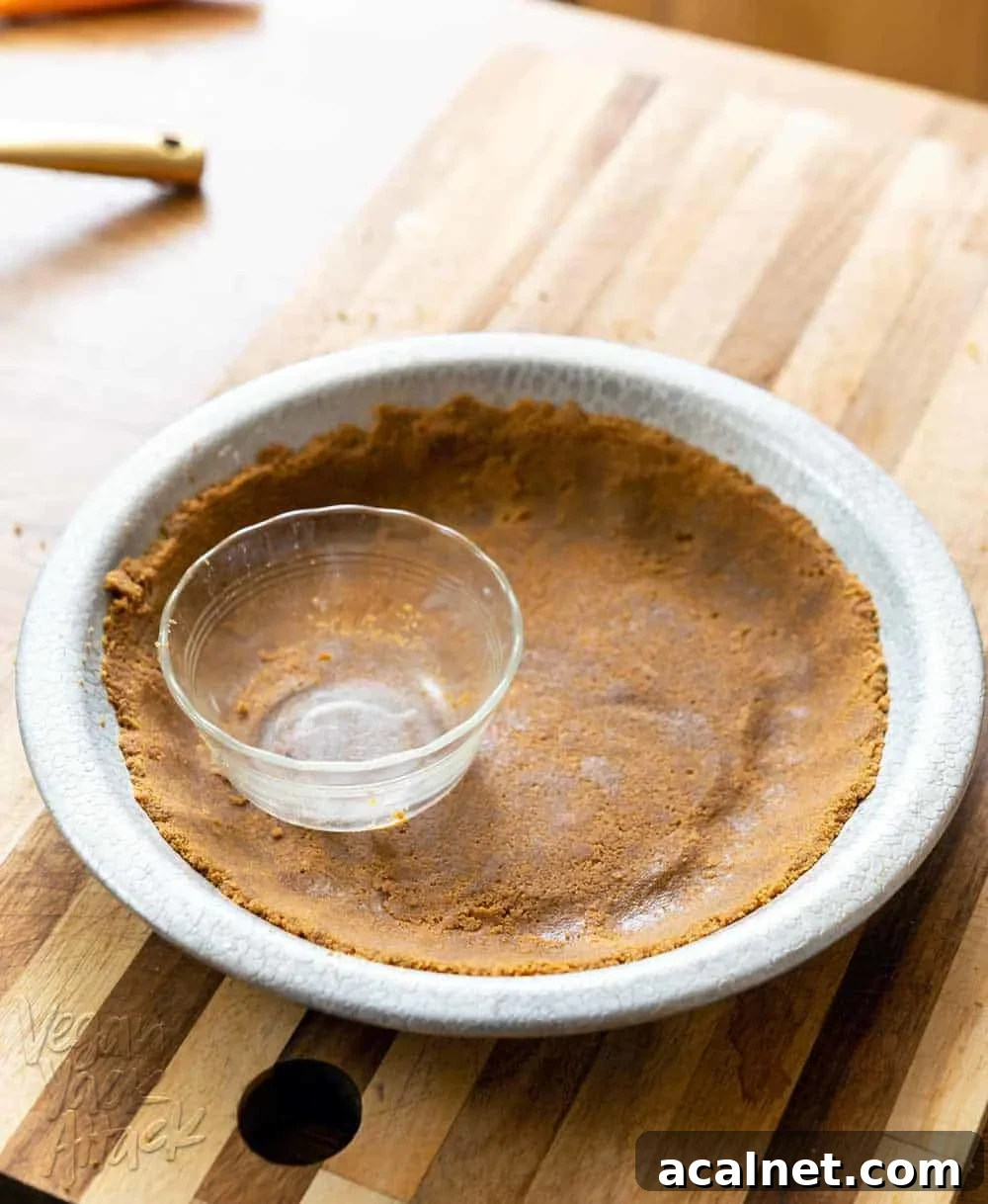 4-Ingredient Vegan Chocolate Pie for Budget Baking 4 Gluten-free graham cracker pie crust in a metal pie pan