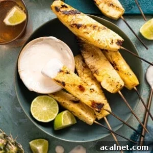 Grilled pineapple served with a coconut rum sauce.