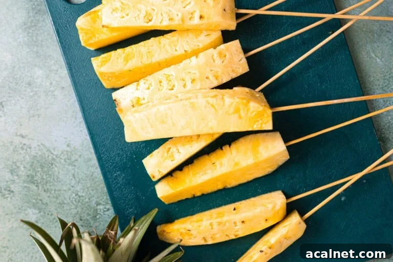 Sliced pineapple on skewers.