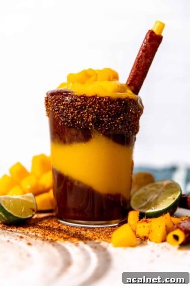 Cup of homemade mangonada served with a tamarindo straw.