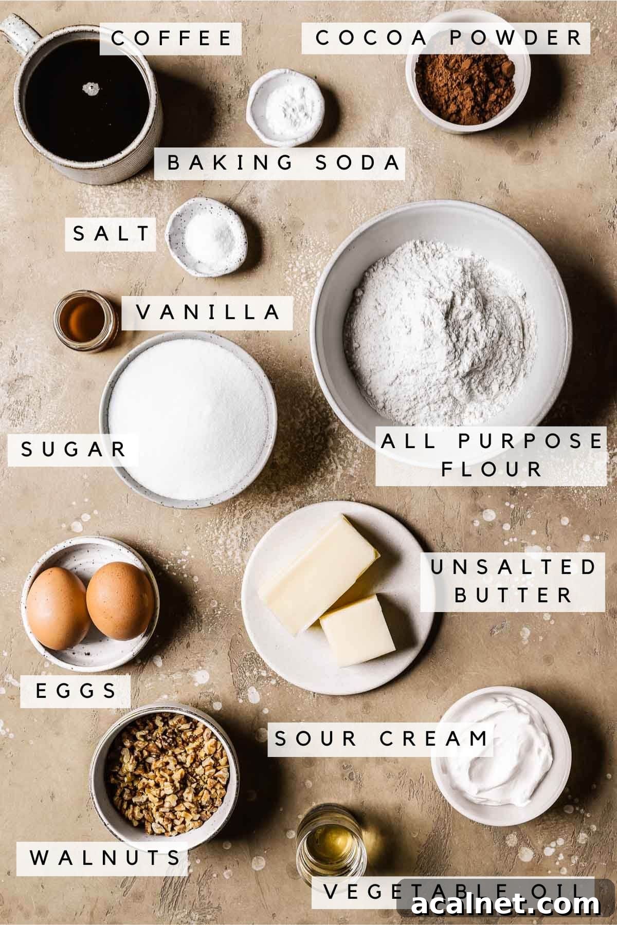 Labeled ingredients in bowls for a chocolate walnut cake.