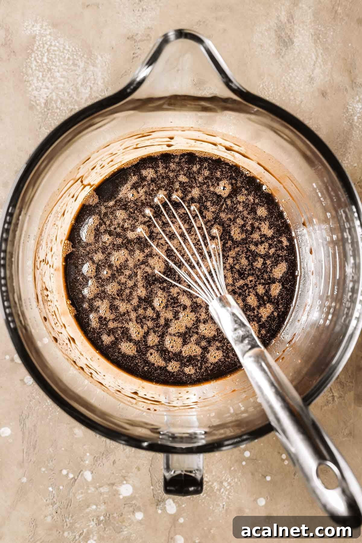 Whisked wet ingredients in a mixing bowl.