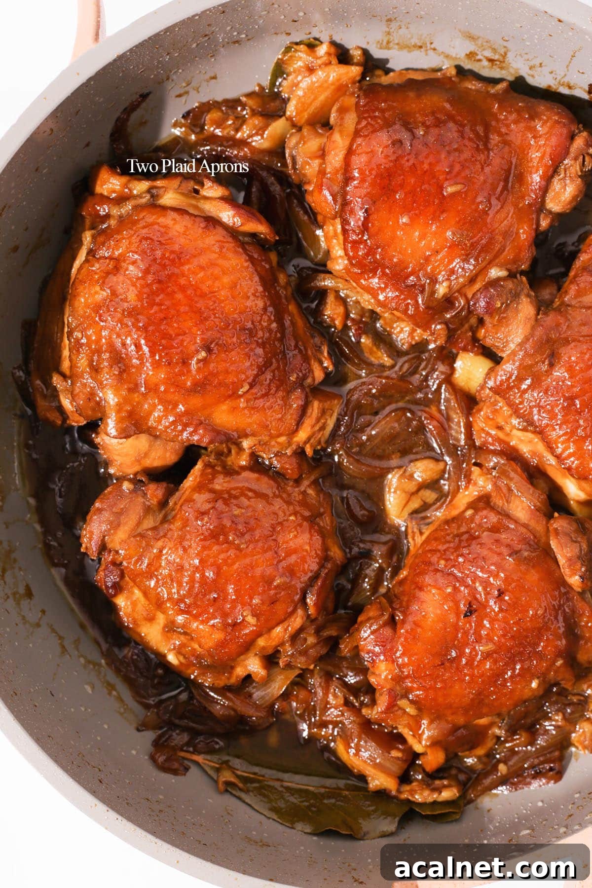 Chicken adobo cooked in pan.