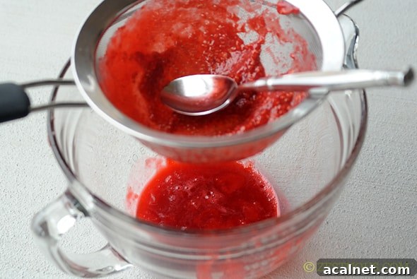 straining raspberry sauce