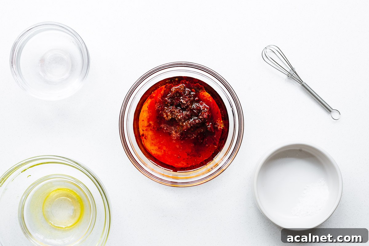 All the harissa vinaigrette ingredients in a small bowl before being mixed.