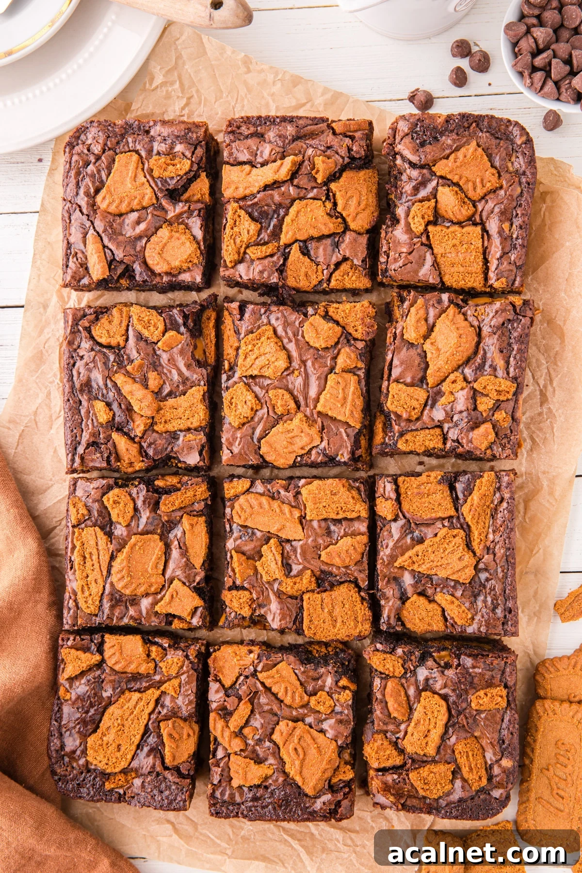 12 brownies topped with chopped Lotus Biscoff cookies.
