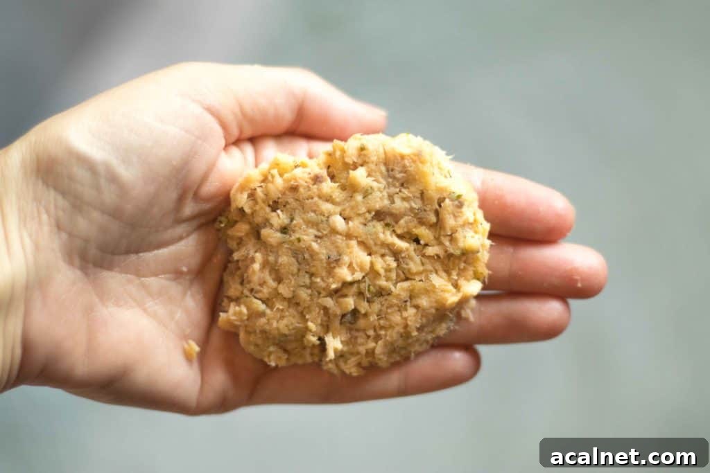 hand holding a formed salmon patty
