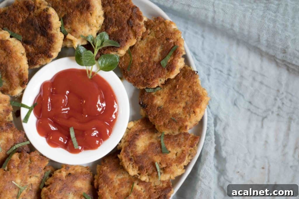 salmon patties on a plate with ketchup