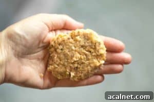 hand holding a formed salmon patty