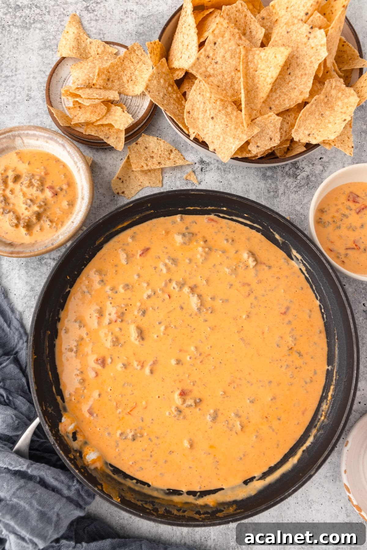 a Skillet full of melted cheese served alongside tortilla chips