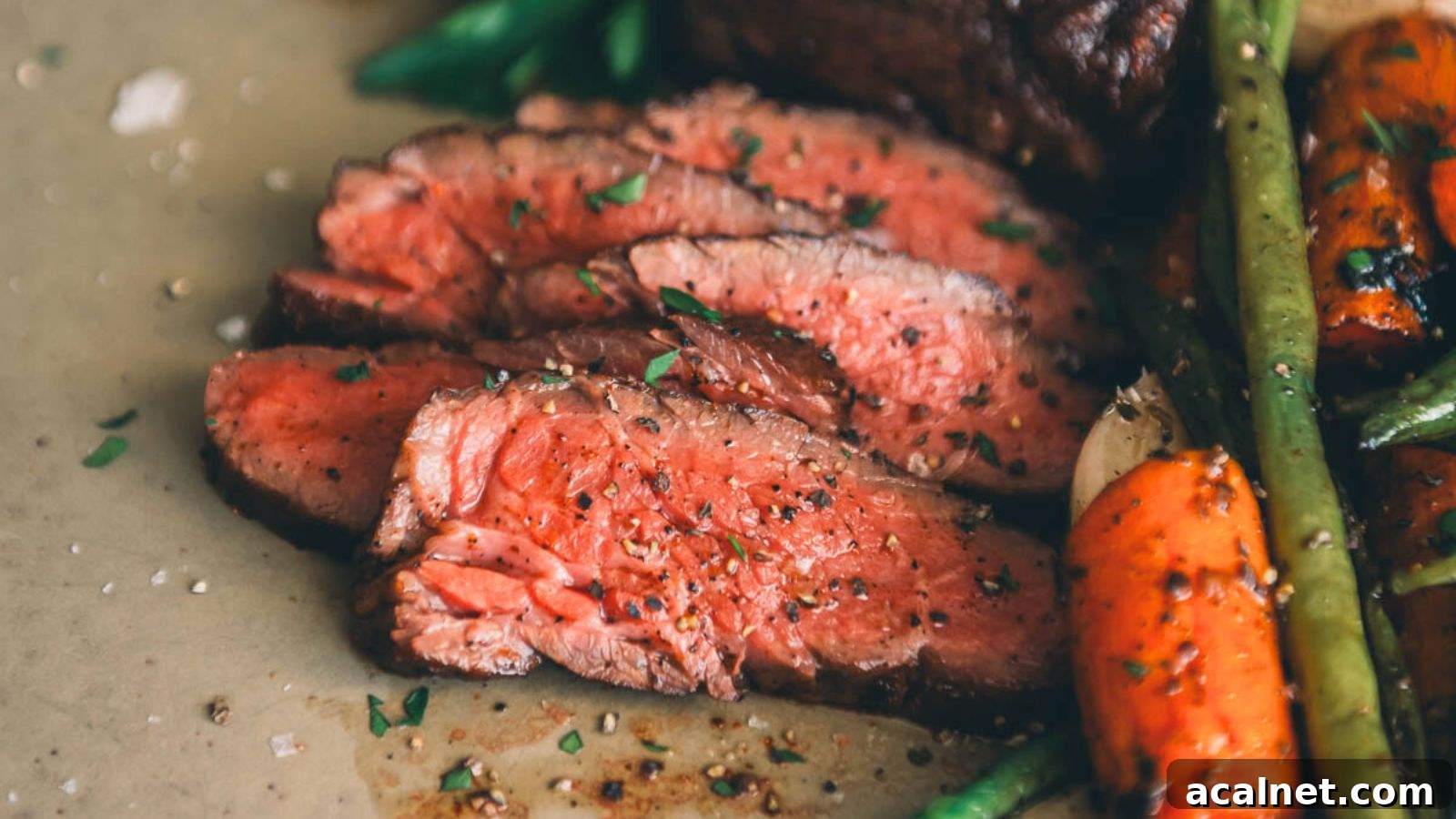 Sous vide Denver steak sliced evenly with rich browned crust and juicy interior.