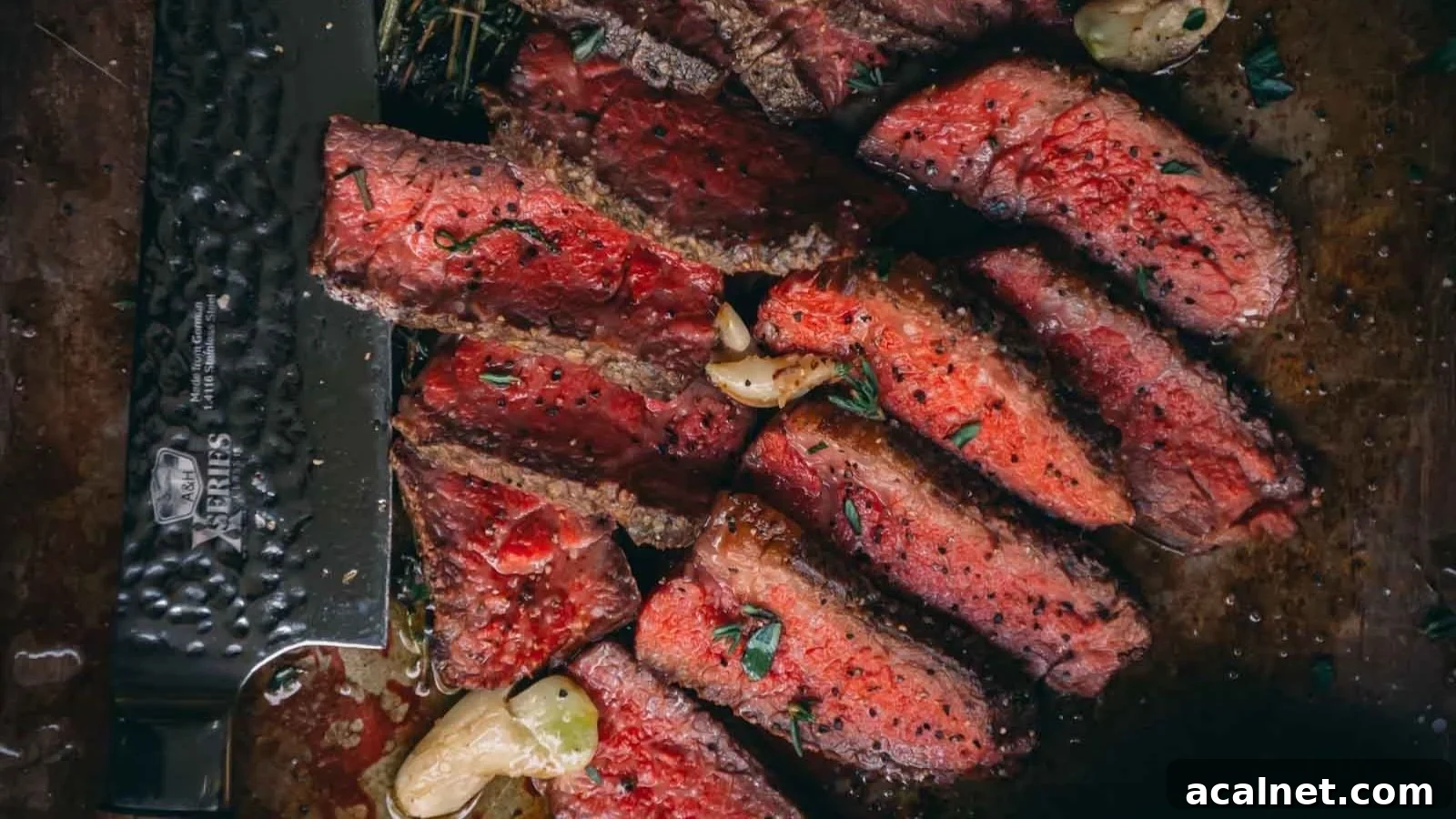 Pan-seared Denver steak with browned crust sliced to show a warm red interior.