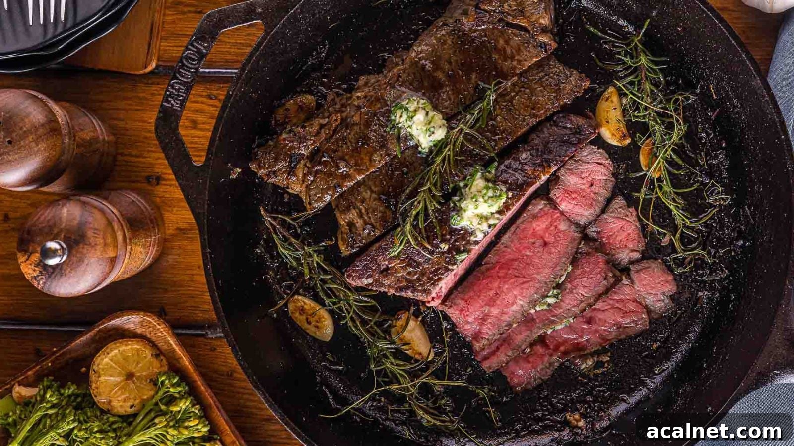 Cast iron steak with a deep sear and butter juices pooling in the pan.