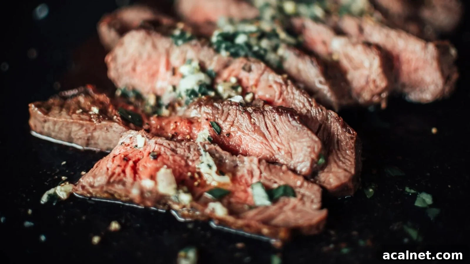 Flat iron steak with shallot herb butter melting across the hot seared surface.