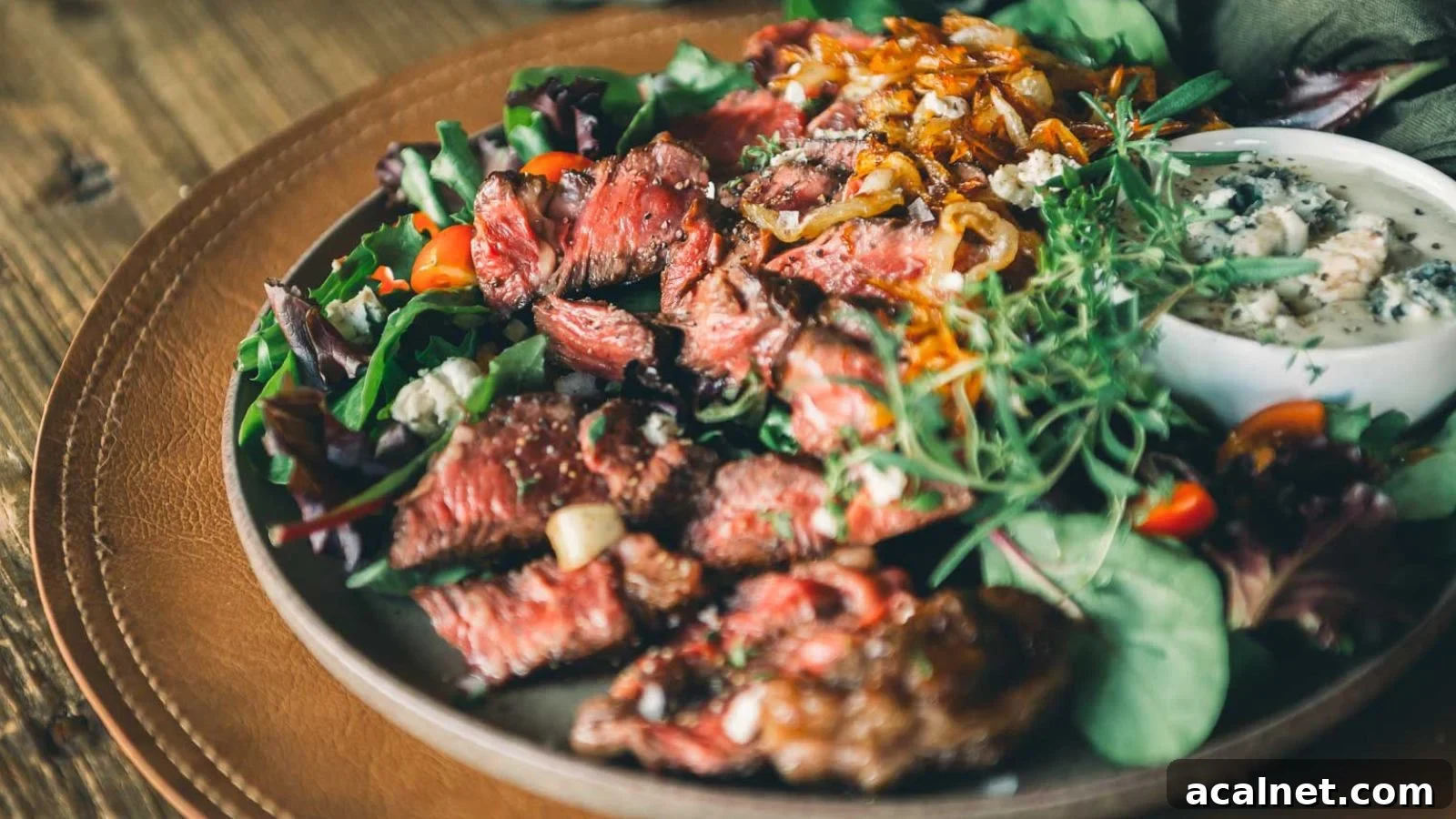 Pan-seared chuck eye steaks sliced to show juicy pink centers with browned crust.