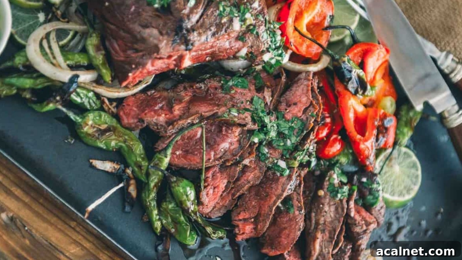 Grilled hanger steak sliced thin with juices pooling beneath the seared edges.