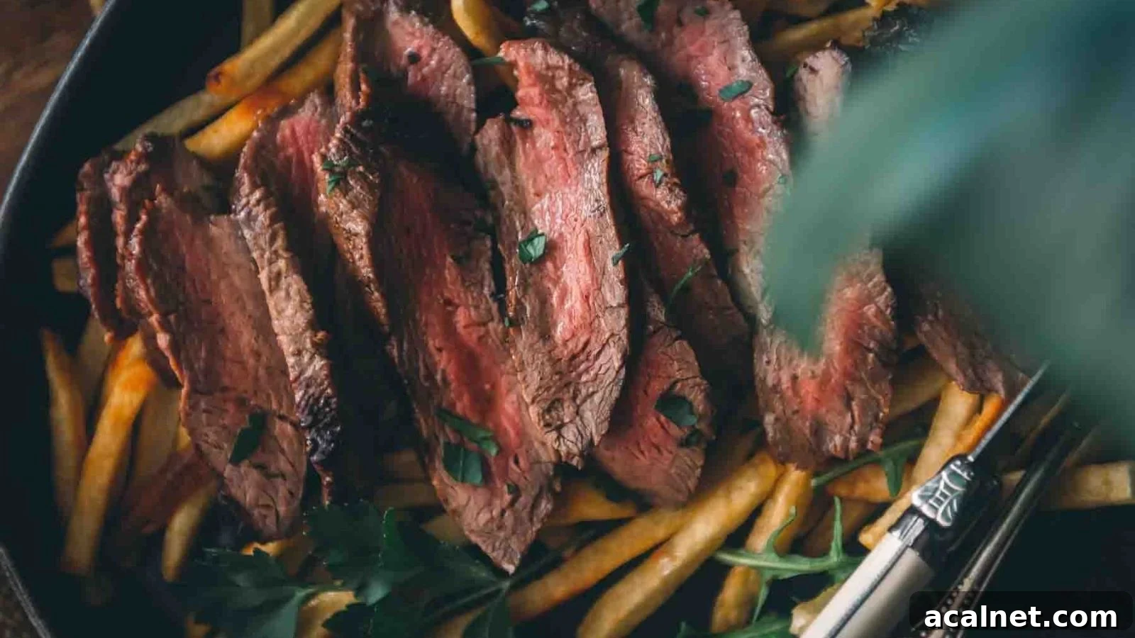Pan-seared merlot steak cooked with wine reduction and sliced to show tenderness.