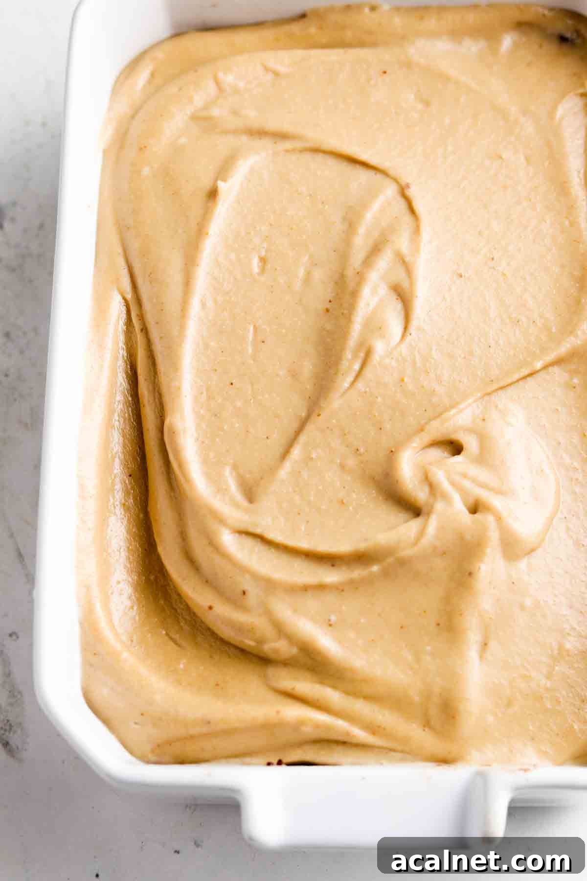 Peanut butter cashew cream filling poured over the brownie crust.