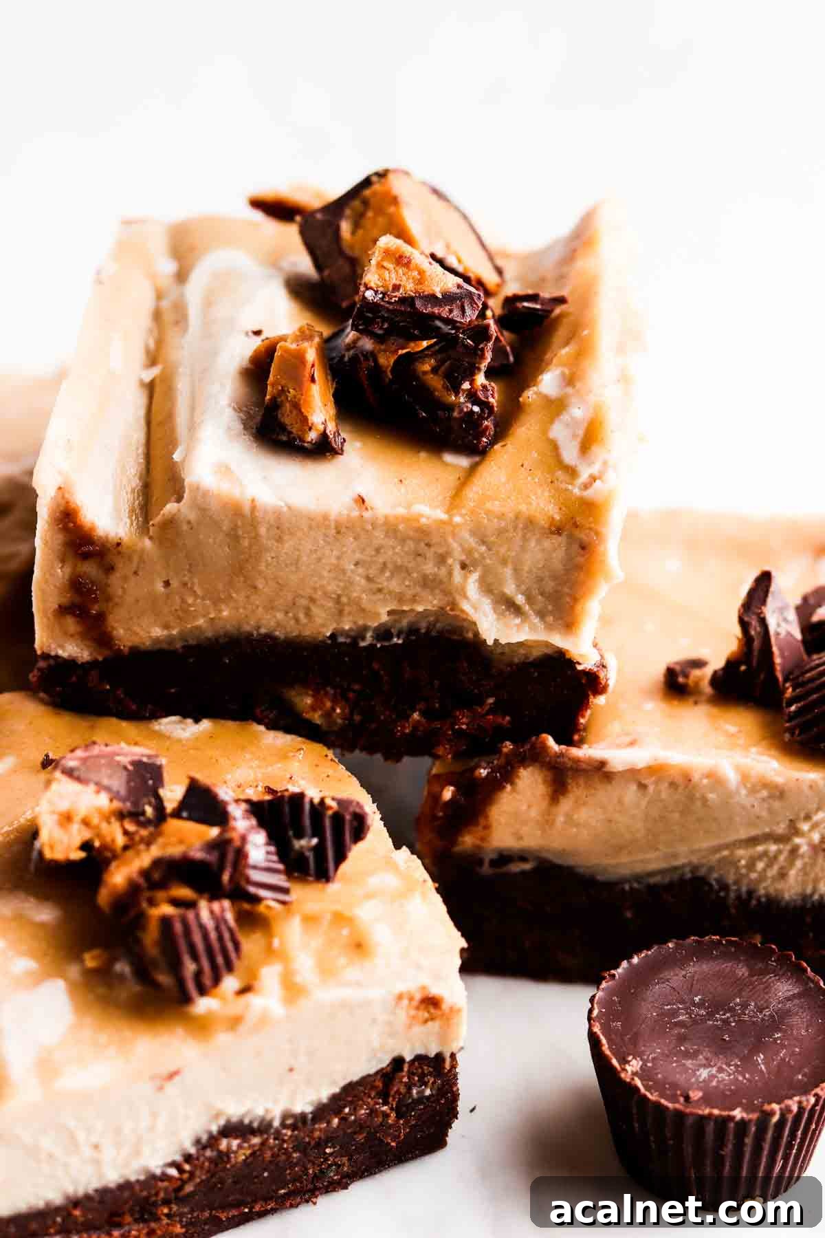 Stacked up cheesecake bars on a plate.