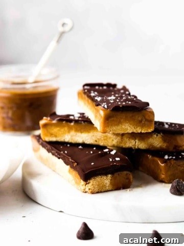 Vegan and gluten free twix bars stacked up on a plate with