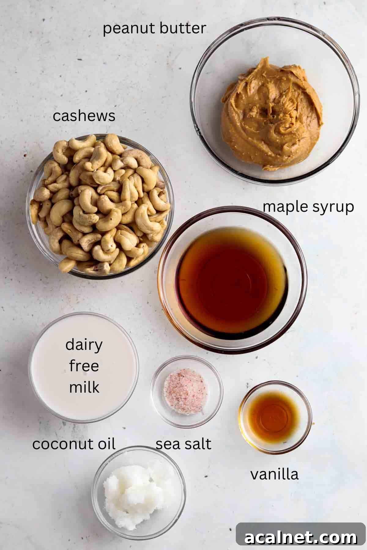 Peanut butter cheesecake filling ingredients laid out in clear bowls.