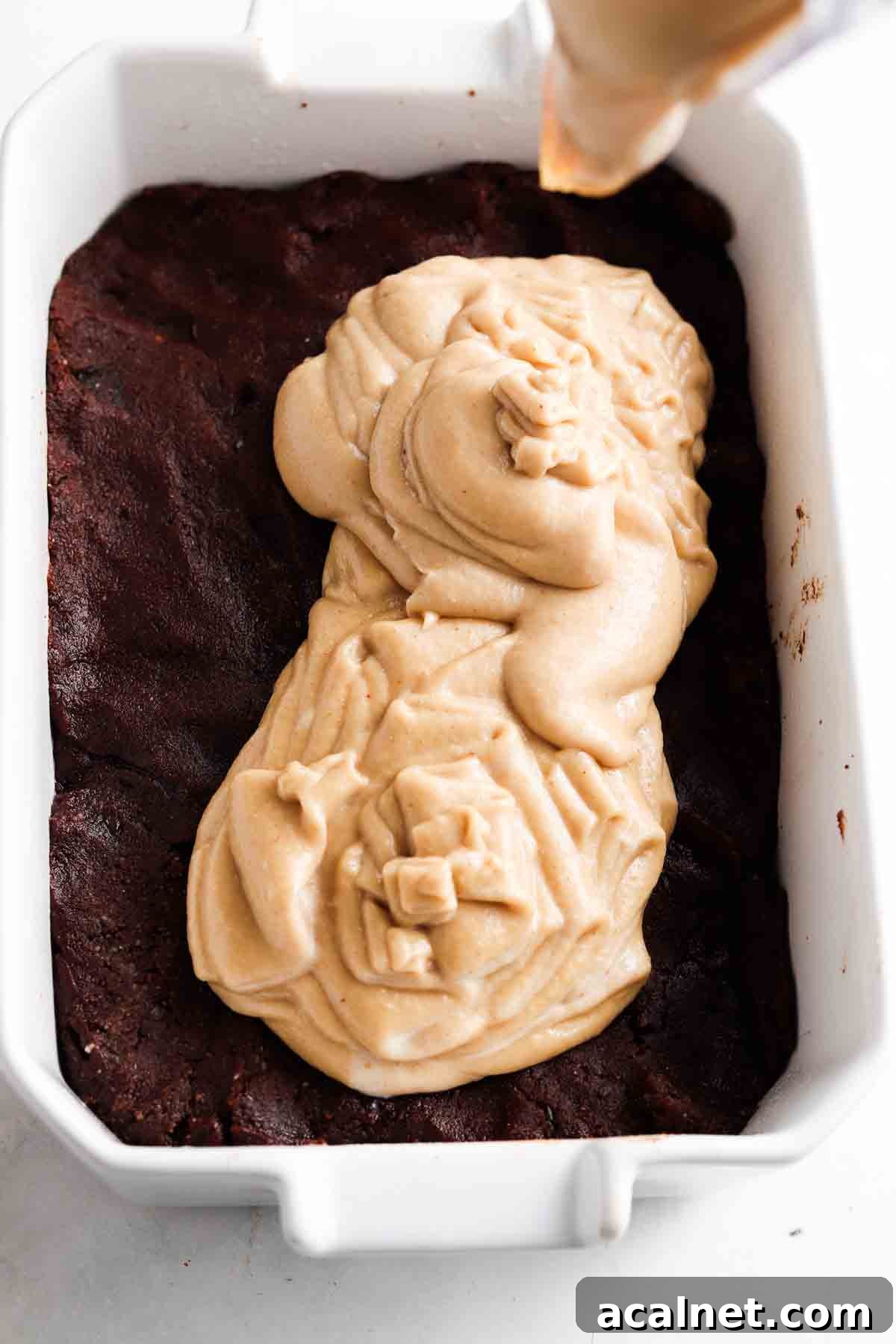 Gluten free brownie cheesecake crust in a casserole dish.