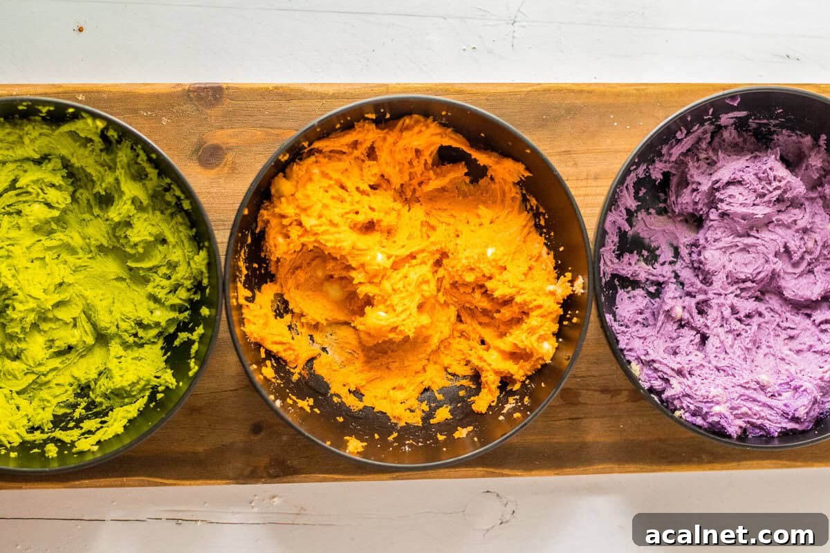 Halloween Sprinkle Cookie Recipe for Festive Party Treats 11 Cookie dough separated into bowls, each dyed a different color (green, orange, purple).