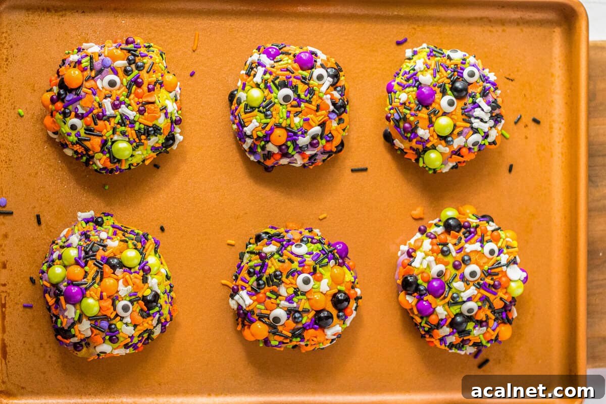 Halloween Sprinkle Cookie Recipe for Festive Party Treats 13 Baked Halloween sprinkle cookies coated in candies.