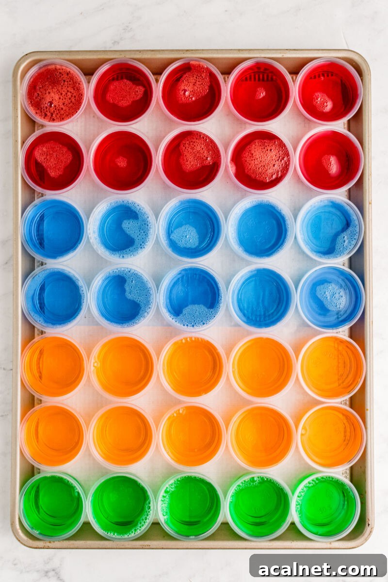Vodka Jello Shot Recipe: Party-Friendly Jiggly Cocktails 2 baking sheet of cherry, blue berry, orange, and lime jello shots