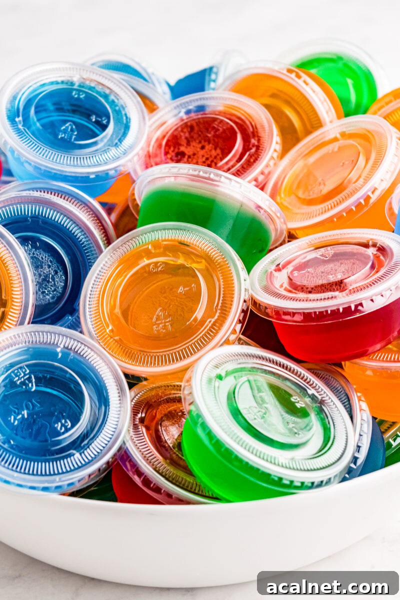 Vodka Jello Shots are a classic party cocktail that's easy to whip up and can be made in any flavor of Jello you love! Be sure to make a bunch, they go fast! close up of jello shots in a white bowl