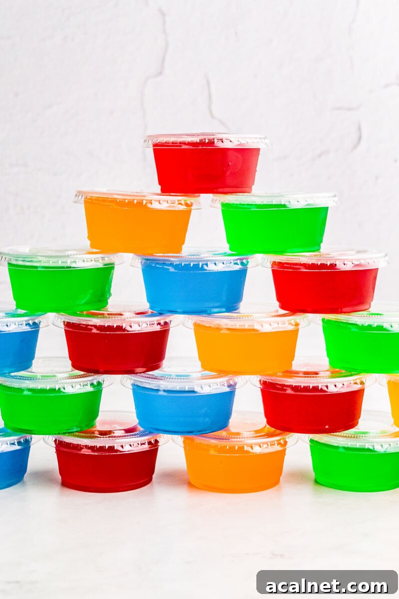 Vodka Jello Shots are a classic party cocktail that's easy to whip up and can be made in any flavor of Jello you love! Be sure to make a bunch, they go fast! jello shots stacked in a pyramid
