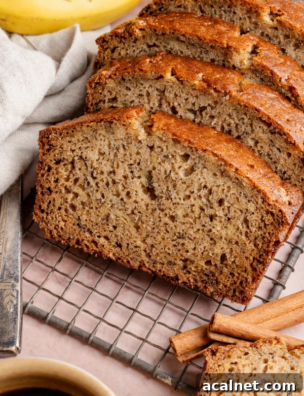 Slices of brown butter banana bread on wire rack.