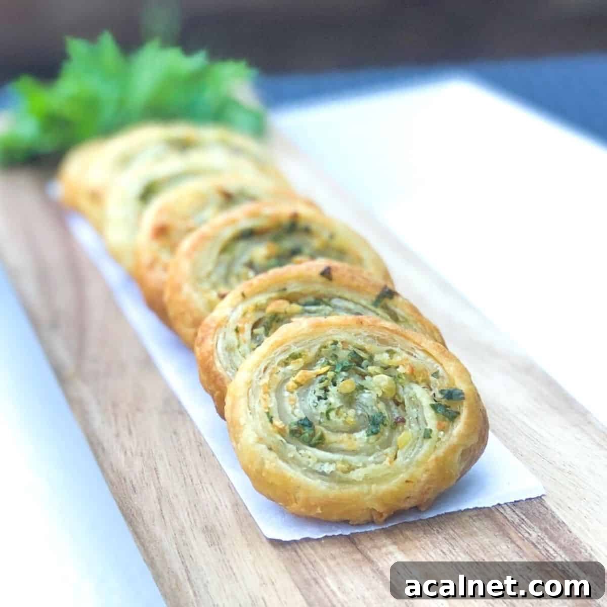 puff pastry pinwheels stacked against each other on board