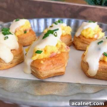 Egg tarts with cream sauce over top.